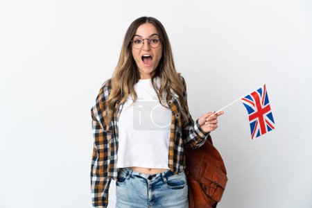 Young Romanian woman holding an United Kingdom flag isolated on white background with surprise facial expression