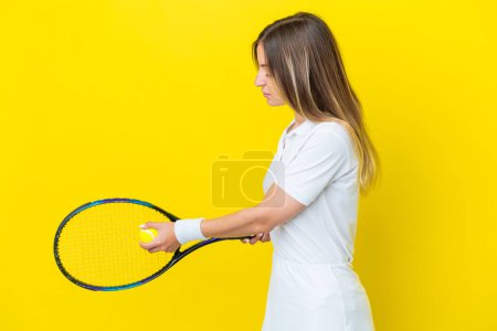 Photo for Young Romanian woman isolated on yellow background playing tennis - Royalty Free Image