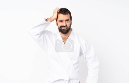 Young man doing karate over isolated white background with an expression of frustration and not understanding