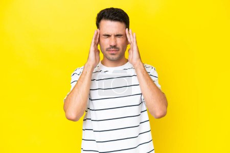 Photo for Young handsome man over isolated yellow background with headache - Royalty Free Image