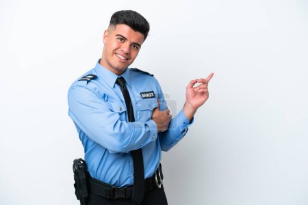 Téléchargez les photos : Jeune homme caucasien de police isolé sur fond blanc pointant du doigt sur le côté - en image libre de droit