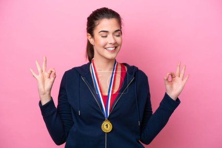 Photo for Young Brazilian sport woman with medals isolated on pink background in zen pose - Royalty Free Image