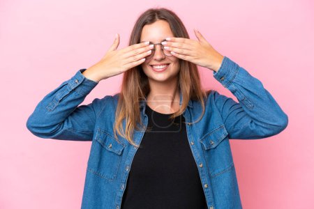 Photo for Young caucasian woman isolated on pink background covering eyes by hands and smiling - Royalty Free Image