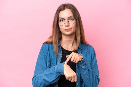 Photo for Young caucasian woman isolated on pink background making the gesture of being late - Royalty Free Image