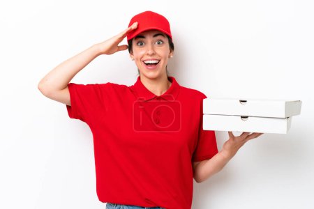 Photo for Pizza delivery caucasian woman with work uniform picking up pizza boxes isolated on white background with surprise expression - Royalty Free Image