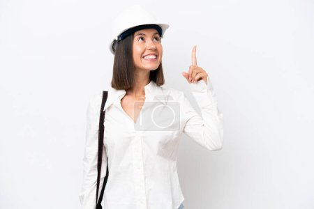 Photo for Young architect woman with helmet and holding blueprints isolated on white background pointing up a great idea - Royalty Free Image