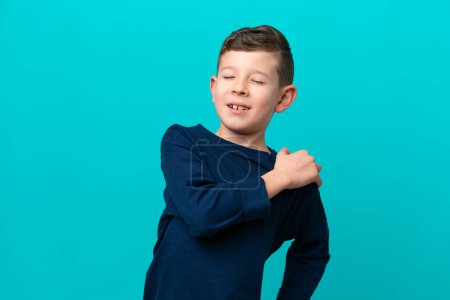 Photo for Little kid boy isolated on blue background suffering from pain in shoulder for having made an effort - Royalty Free Image