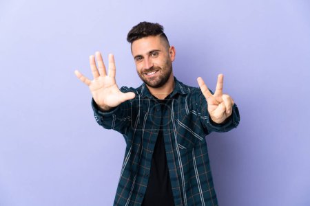 Photo for Caucasian man isolated on purple background counting seven with fingers - Royalty Free Image