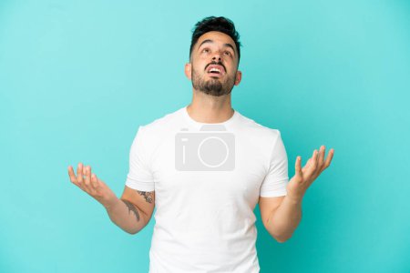 Photo for Young caucasian man isolated on blue background stressed overwhelmed - Royalty Free Image