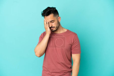 Photo for Young caucasian man isolated on blue background with headache - Royalty Free Image