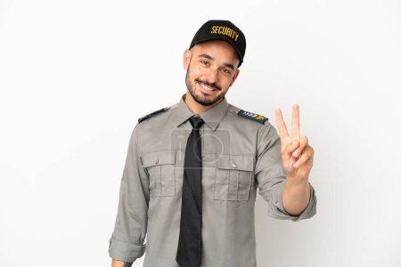 Photo for Young security  caucasian man isolated on white background smiling and showing victory sign - Royalty Free Image