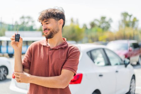 Photo for Young Arabian handsome man holding car key at outdoors with sad expression - Royalty Free Image