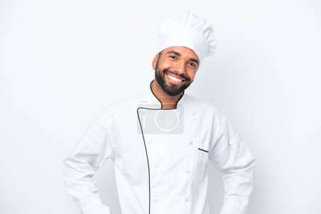 Photo for Young Brazilian chef man isolated on white background posing with arms at hip and smiling - Royalty Free Image