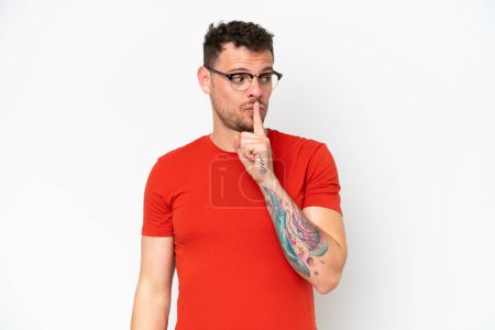 Photo for Young caucasian handsome man isolated on white background showing a sign of silence gesture putting finger in mouth - Royalty Free Image