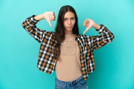 Photo for Young French woman isolated on blue background showing thumb down with two hands - Royalty Free Image