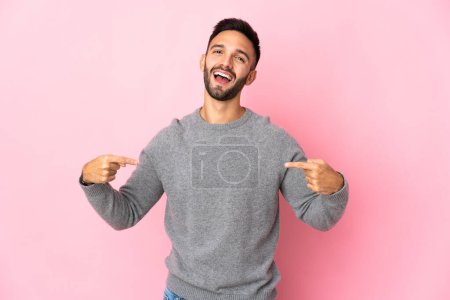 Photo for Young caucasian man isolated on pink background proud and self-satisfied - Royalty Free Image