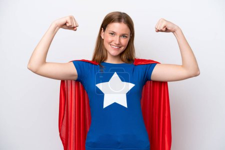 Photo for Young caucasian woman isolated on white background in superhero costume and doing strong gesture - Royalty Free Image
