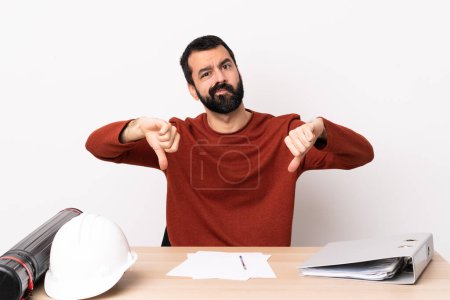 Téléchargez les photos : Architecte caucasien homme avec barbe dans une table montrant pouce vers le bas avec deux mains. - en image libre de droit