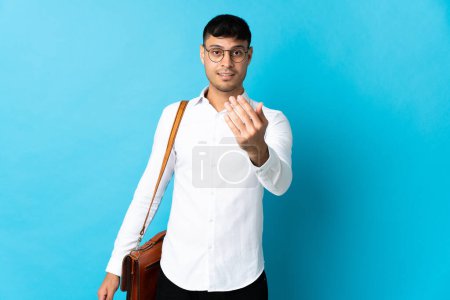 Photo for Young business Colombian man isolated on blue background inviting to come with hand. Happy that you came - Royalty Free Image