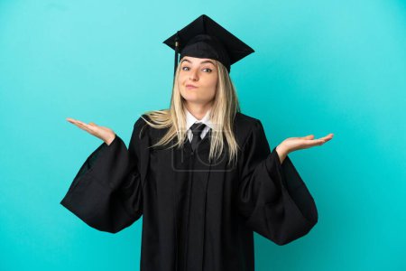 Photo for Young university graduate over isolated blue background having doubts while raising hands - Royalty Free Image