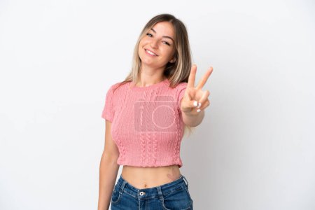 Photo for Young Romanian woman isolated on white background smiling and showing victory sign - Royalty Free Image