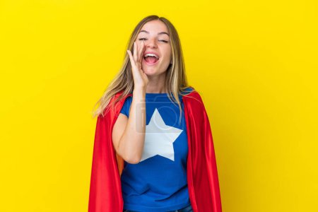 Photo for Super Hero Romanian woman isolated on yellow background shouting with mouth wide open - Royalty Free Image