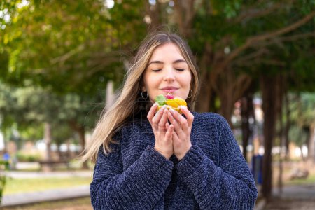 Photo for Young pretty Romanian woman holding a tartlet at outdoors - Royalty Free Image