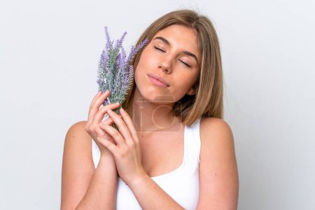 Young caucasian woman isolated on white background holding a lavender plant. Close up portrait