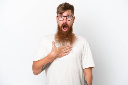 Photo for Redhead man with long beard isolated on white background surprised and shocked while looking right - Royalty Free Image