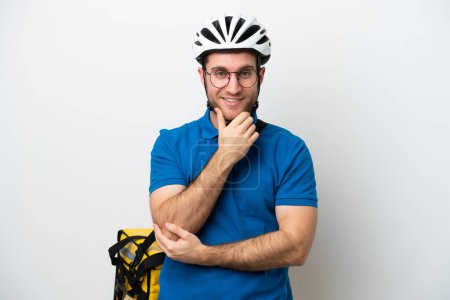 Young caucasian man with thermal backpack isolated on white background with glasses and smiling
