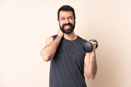 Photo for Caucasian sport man with beard making weightlifting over isolated background laughing - Royalty Free Image