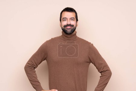Photo for Man over isolated background posing with arms at hip and smiling - Royalty Free Image