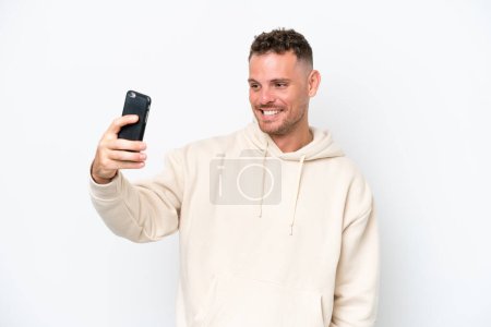 Photo for Young caucasian handsome man isolated on white background making a selfie - Royalty Free Image