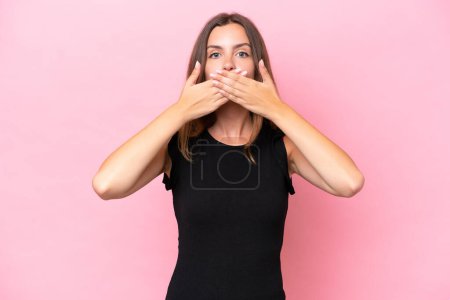 Photo for Young caucasian woman isolated on pink background covering mouth with hands - Royalty Free Image