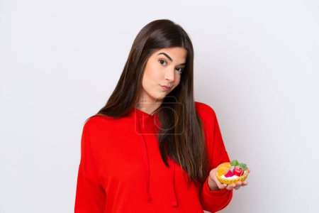 Photo for Young Brazilian woman holding a tartlet isolated on white background with sad expression - Royalty Free Image