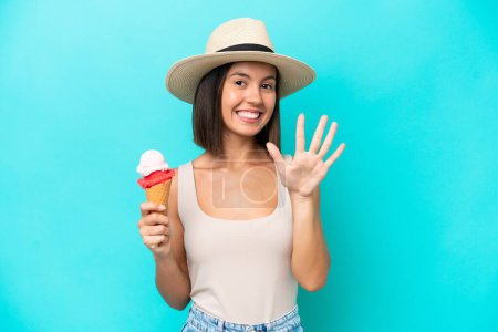 Photo for Young caucasian woman holding an ice cream isolated on blue background counting five with fingers - Royalty Free Image