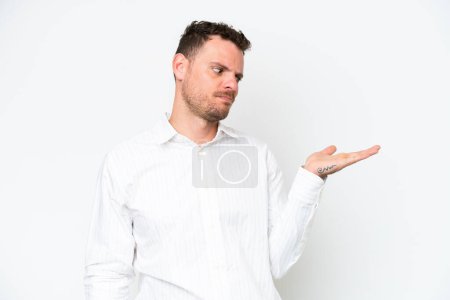 Photo for Young caucasian handsome man isolated on white background holding copyspace with doubts - Royalty Free Image