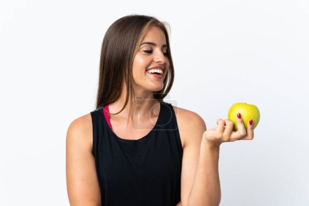 Téléchargez les photos : Jeune femme uruguayenne isolée sur fond blanc avec une pomme et heureuse - en image libre de droit