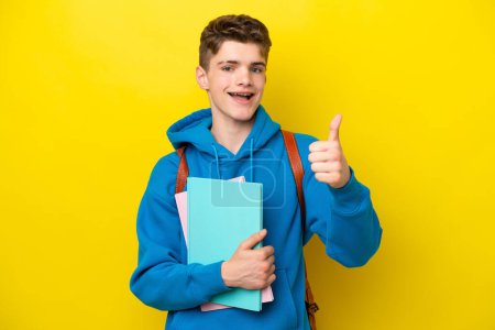 Photo for Teenager Russian student man isolated on yellow background with thumbs up because something good has happened - Royalty Free Image