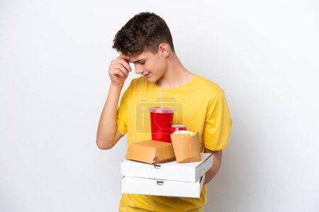 Photo for Teenager Russian man holding fast food isolated on  white background laughing - Royalty Free Image