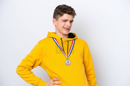Photo for Teenager Russian man with medals isolated on white background suffering from backache for having made an effort - Royalty Free Image