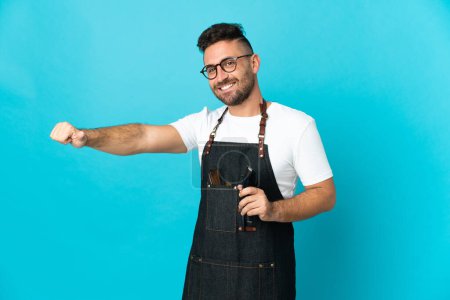 Barber man in an apron giving a thumbs up gesture