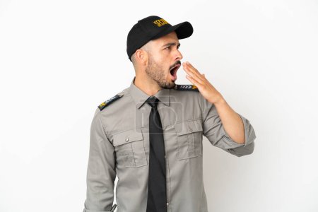 Photo for Young security  caucasian man isolated on white background yawning and covering wide open mouth with hand - Royalty Free Image