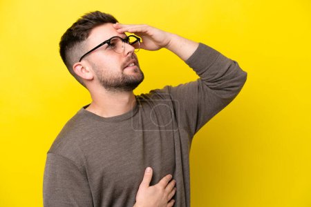 Photo for Young caucasian man isolated on yellow background With glasses and tired - Royalty Free Image