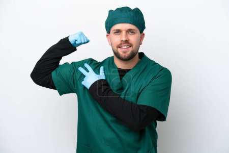 Photo for Surgeon in green uniform isolated on white background doing strong gesture - Royalty Free Image