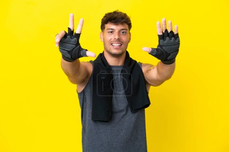 Photo for Young sport caucasian man with towel isolated on yellow background counting eight with fingers - Royalty Free Image