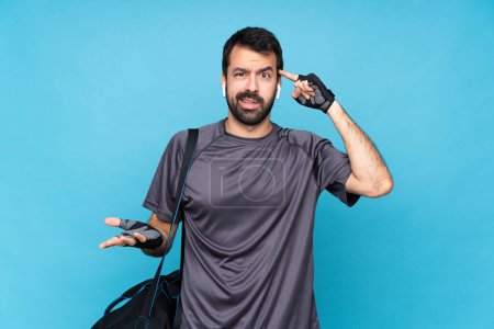Photo for Young sport man with beard over isolated blue background making the gesture of madness putting finger on the head - Royalty Free Image