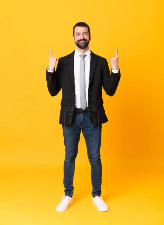 Photo for Full-length shot of business man over isolated yellow background pointing up a great idea - Royalty Free Image