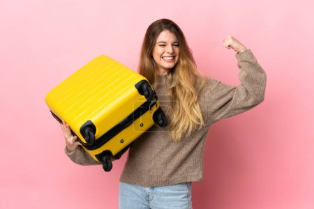 Photo for Traveler woman holding a suitcase isolated on pink background in vacation with travel suitcase - Royalty Free Image
