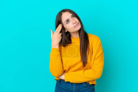 Photo for Young Ukrainian woman isolated on blue background with problems making suicide gesture - Royalty Free Image